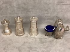 A collection of sterling silver items to include a cruet set and three pepper grinders.