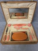 A Mid C20th manicure set, in faux leather box, complete with mirror