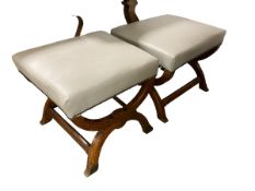 A pair of light green leather and oak footstools with X stretcher