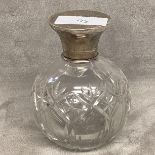 A silver topped scent bottle . With stopper. 11cm