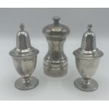 A pair of Adam style pepperettes together with a sterling silver pepper grinder.