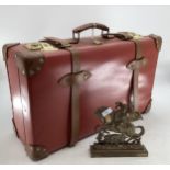 A Globe Trotter Vintage suitcase, a brass door stop and a wall mirror