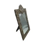 A sterling silver mounted easel backed dressing table mirror with scrolling acanthus leaf decoration