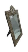 A sterling silver mounted easel backed dressing table mirror with scrolling acanthus leaf decoration