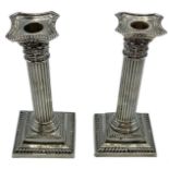 A pair of sterling silver weighted column candlesticks 160 cm H
