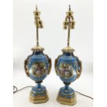 A pair of Continental Meissen Style lamps, on stepped gilded base, the blue body with central oval