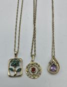 Three 9 ct gold chain link necklaces with gem set pendant 7.60 g