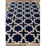 An excellent quality, as new, from original packaging, dark blue and ivory coloured Indian rug,