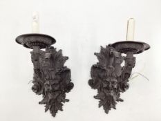A pair of French C19th Bronze single branch wall sconces cast satyr mask with scrolling Rococo