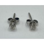 A pair of 9 ct white gold and diamond ear studs