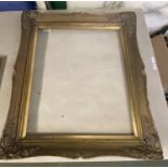 A good quality antique French Rococo style gilded wooden picture frame bearing old labels on reverse