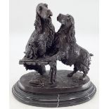 A bronze model of a pair of spaniels, indistinct etched signature, possibly Aaure, on an oval marble