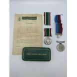 A woman's voluntary service medal, together with Rhodesian district service medal to PR23206 RFN