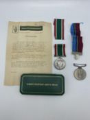 A woman's voluntary service medal, together with Rhodesian district service medal to PR23206 RFN