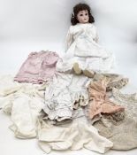 A German porcelain headed doll and doll clothing