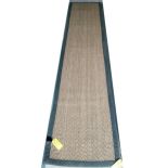 A sisal runner rug, 370 x 75cm, with grey material edging