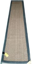 A sisal runner rug, 370 x 75cm, with grey material edging