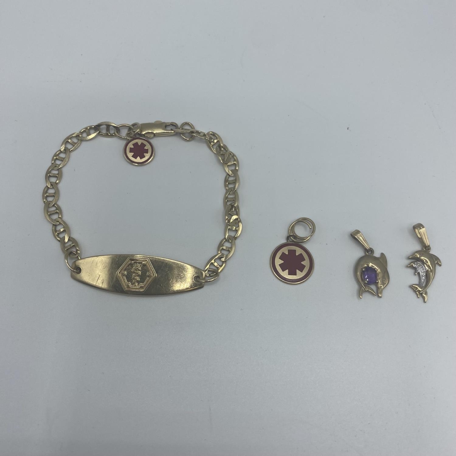 A 10ct gold marked ID bracelet with 9ct and 10ct charms 12.5g - Image 5 of 5