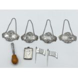 A collection of sterling silver items, to include decanter labels, cheese flags, vesta, and a