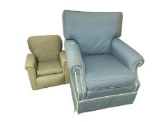 A Peter Guild blue Upholstered arm chair with cream piping, small areas of wear to arms, some wear