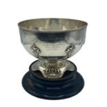Sterling Silver circular bowl with raised floral decoration, on a turned wooden base, Elkington &