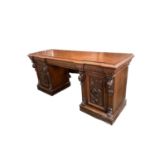 A large heavily carved oak sideboard, with three drawers flanked by two cupboards, 72.5Depth x