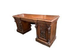 A large heavily carved oak sideboard, with three drawers flanked by two cupboards, 72.5Depth x