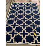 An excellent quality, as new from original packaging, dark blue and ivory coloured Indian rug,