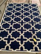 An excellent quality, as new from original packaging, dark blue and ivory coloured Indian rug,