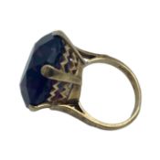 A 9ct gold dress ring, single circular free cut amethyst coloured paste stone in a six claw setting,