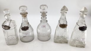 A collection of C19th/C20th glass decanters, a triple ring necked example, some with white metal
