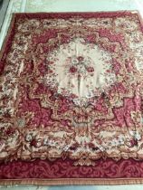 A needlepoint rug, with pink ground and central medallion of roses