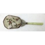 A dressing table hand mirror, decorated to back with carved jade style flowers and fauna