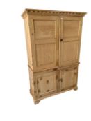 A light pine two sectioned house keepers cupboard, of small proportions, 126 cm W x 49.5 cm D x