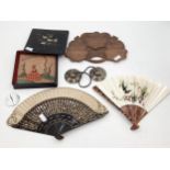 A collection of oriental items to include a lacquer box, two fans, carved tray etc