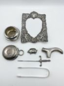 A collection of Sterling silver items, a walking cane handle, pig pin cushion, etc