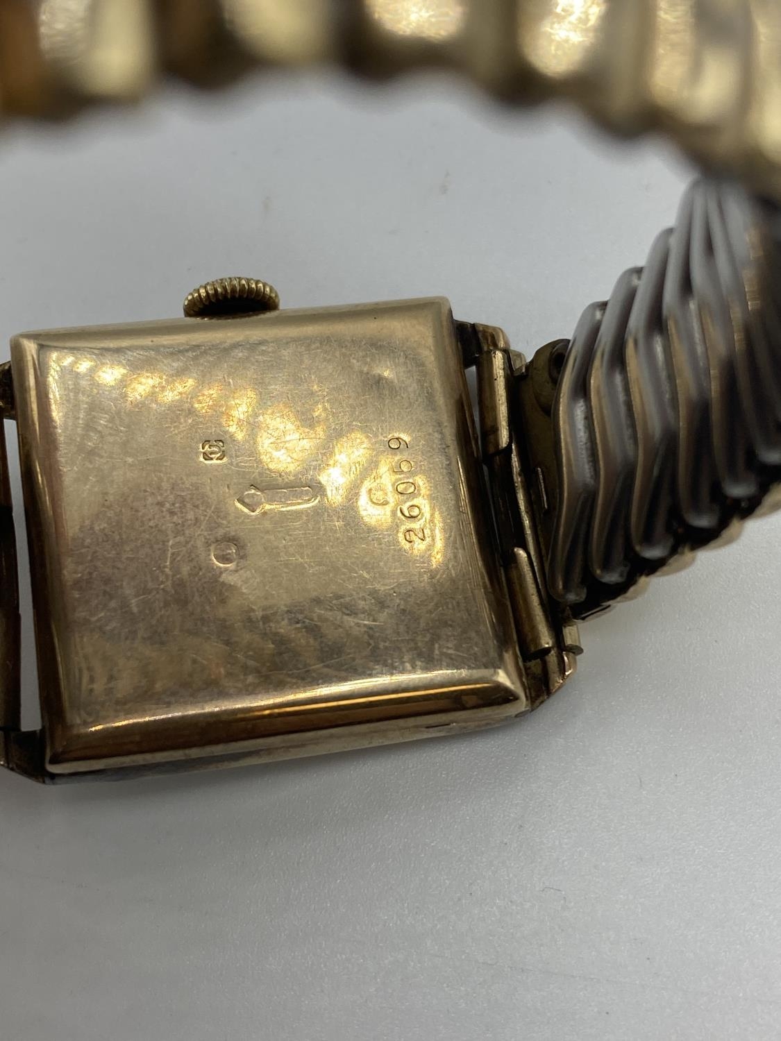 A 9ct gold cased gents watch, rectangular case with Roman numeral markers, on rolled gold strap, - Image 3 of 5