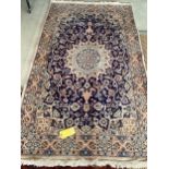 A Persian wool rug, blue and beige ground, with central star medallion, 114cm x 215cm, cleared
