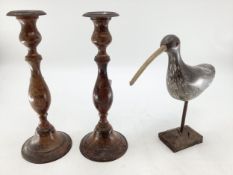 A pair of Indian metal candlesticks together with a carved model of a bird on stand, (Sticks 35cmh)