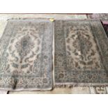 An excellent quality near pair of rugs, Persian, silk and wool, with beige ground and blue floral