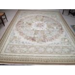 Aubusson needlepoint rug, in greens and creams, with pink medallions of roses to centre, 267 x 365cm