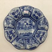 An oriental style blue and white slip ware , 9 lobbed Frankfurt Faience "buckel platte" charger 31cm