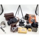 A collection of vintage cameras and equipment to include a Box Brownie and a Kodak Petina