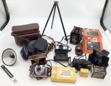 A collection of vintage cameras and equipment to include a Box Brownie and a Kodak Petina