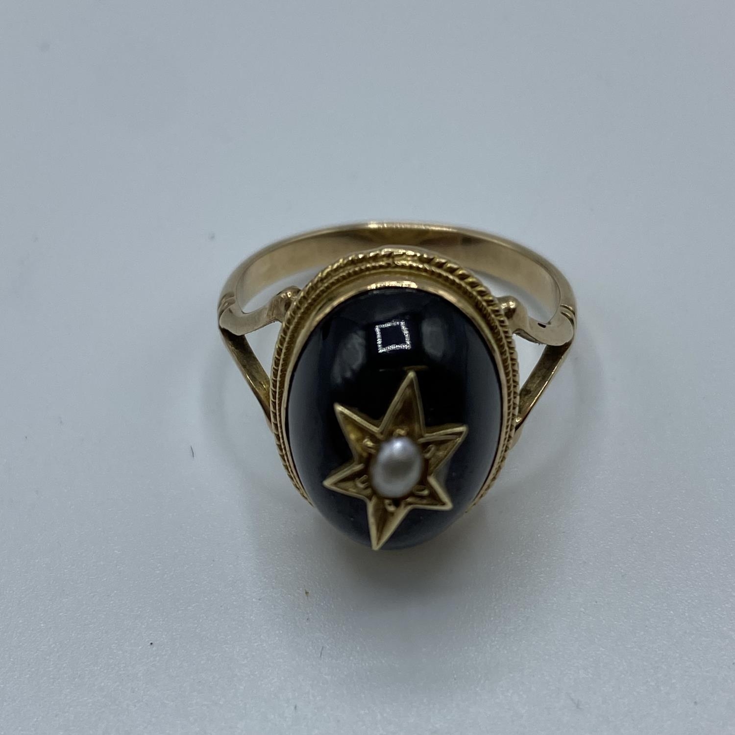 A Victorian unmarked yellow metal garnet and seed pearl dress ring, oval cabochon garnet with star - Image 3 of 5