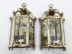 A pair of brass wall lanterns, with bevelled glass panes, 52cmH