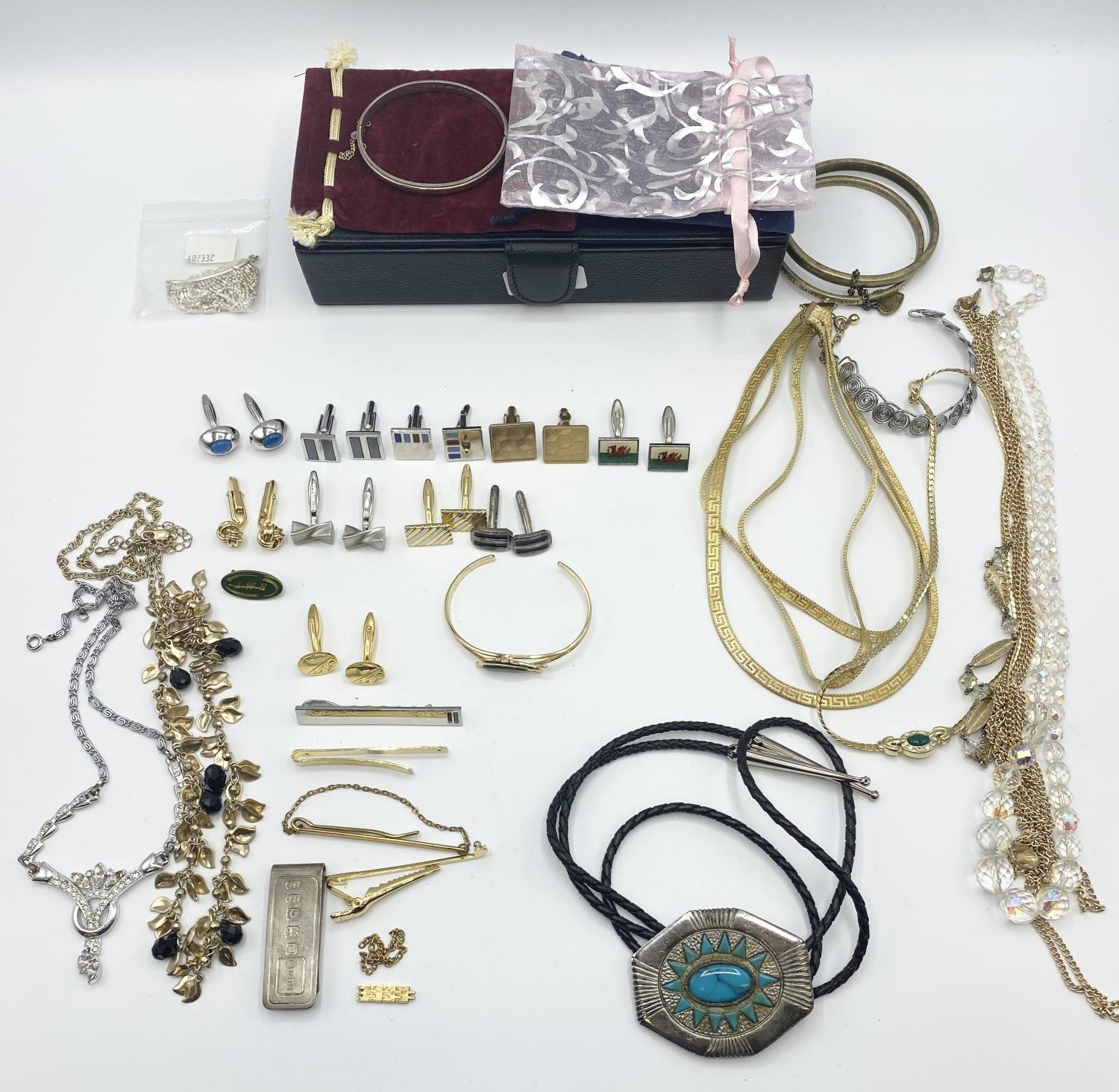 A collection of costume jewellery and a silver money clip.