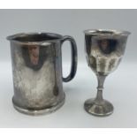 A sterling silver mug with glass bottom. Birmingham 1934. Together with a white metal wine goblet