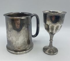 A sterling silver mug with glass bottom. Birmingham 1934. Together with a white metal wine goblet