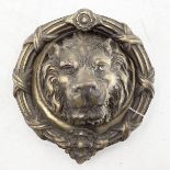Large brass door knocker in the form of a lions head